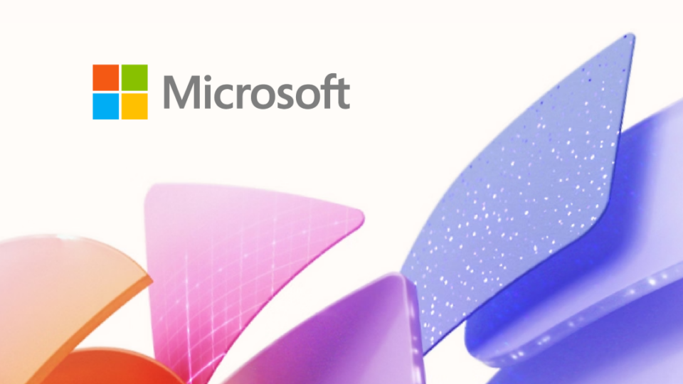 An image with the Microsoft name and logo slightly left of center at the top and orange and purple triangles then blue squares across the bottom of the image.