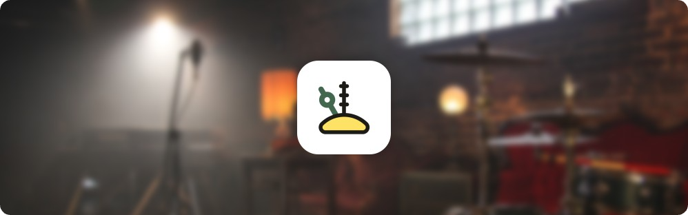Tack logo in the foreground against an out-of-focus band rehearsal room
