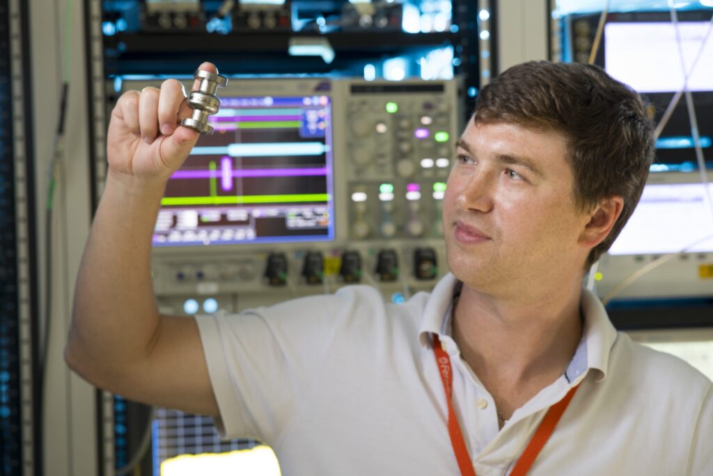 Viable quantum computing technology relies on the development of qubits that can maintain quantum information for periods of time longer than 1 second Viable quantum computing technology relies on the development of qubits that can maintain quantum information for periods of time longer than 1 second. At Fermilab, scientists and engineers are turning to existing particle accelerator technology to achieve this goal. In this image, a scientist features a small SRF cavity for use in quantum systems.