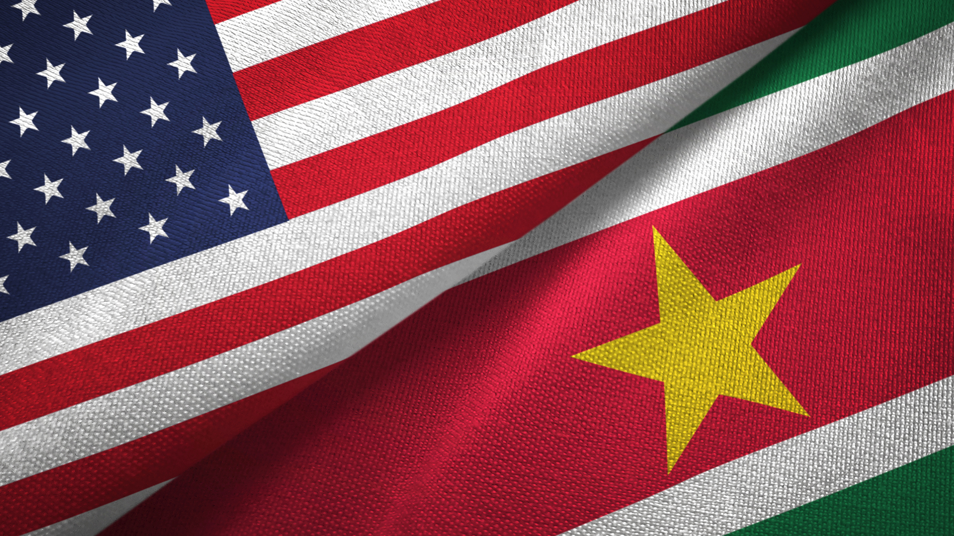 United States of America and Suriname Country Flags Overlapping each other with fabric texture.